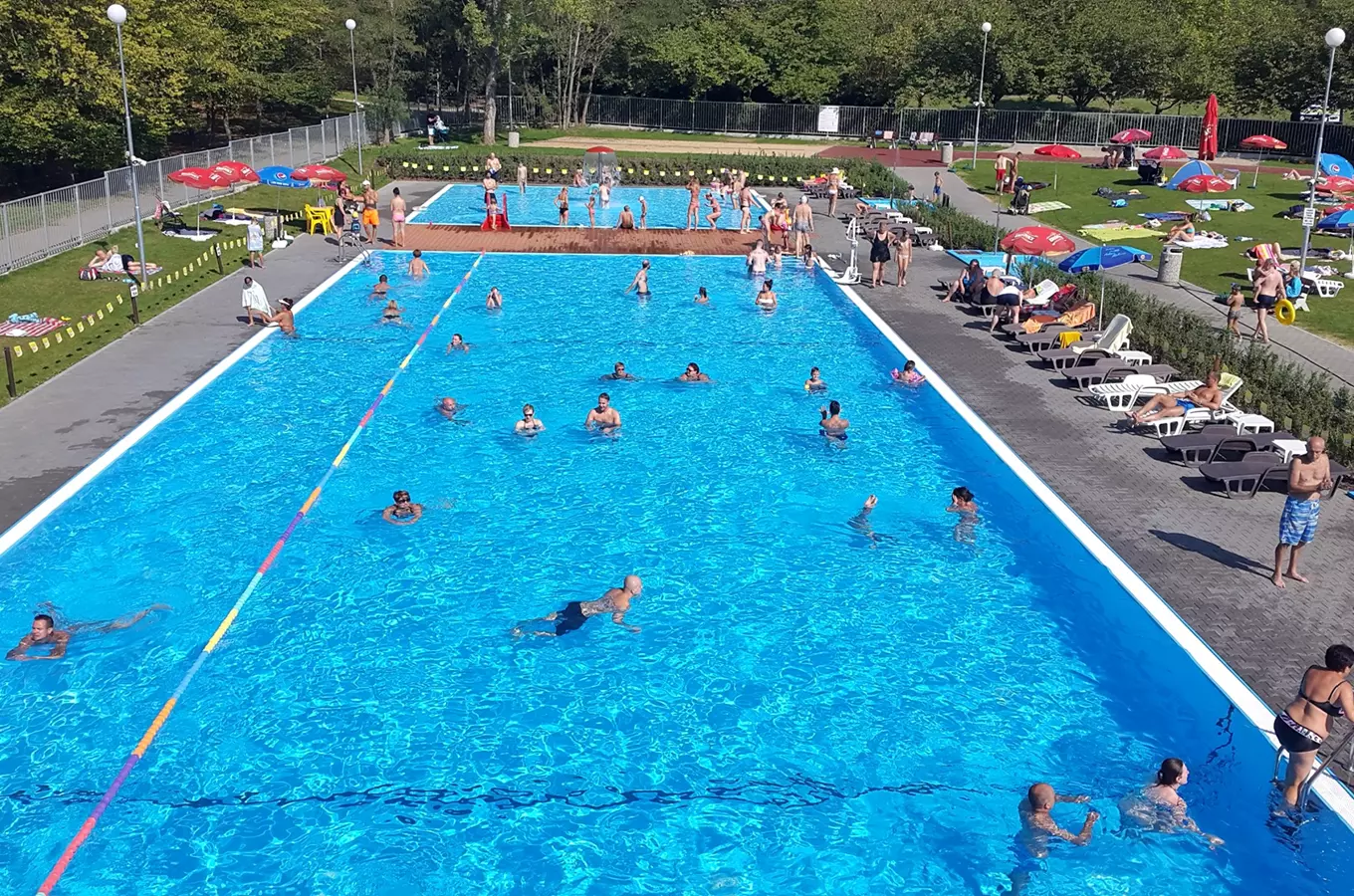 Outdoor swimming pool with swimmers