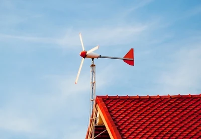 Malá domácí větrná turbína na střechě domu.