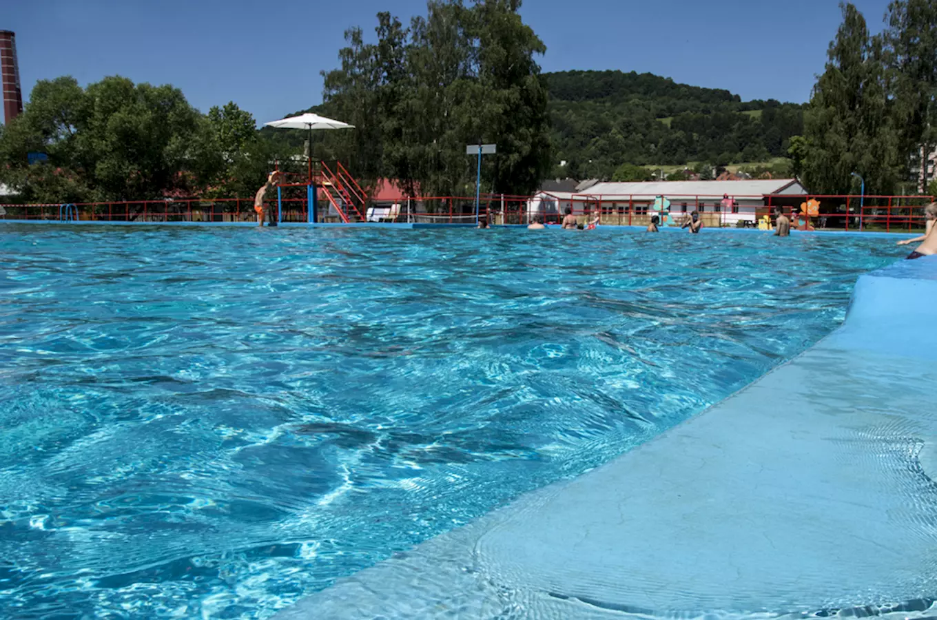 Outdoor swimming pool with people