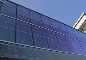 Fotografie fasády budovy s velkými skleněnými panely.