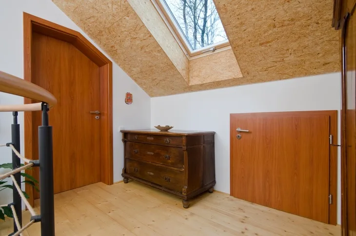 Dveře v interiéru s architektonickým detaillem a skleněným stropem.