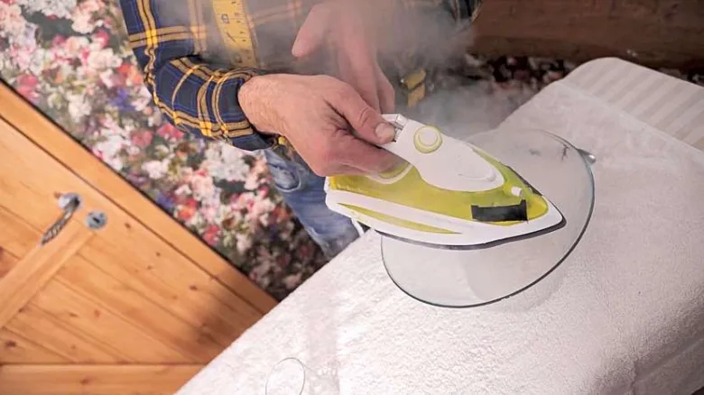 Person ironing clothes with steam