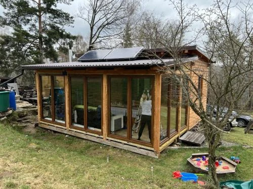 Nová dřevěná stavba s velkými okny po montážních pracích.